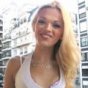 Cute smiling slender blonde shemale vamp in high heeled boots